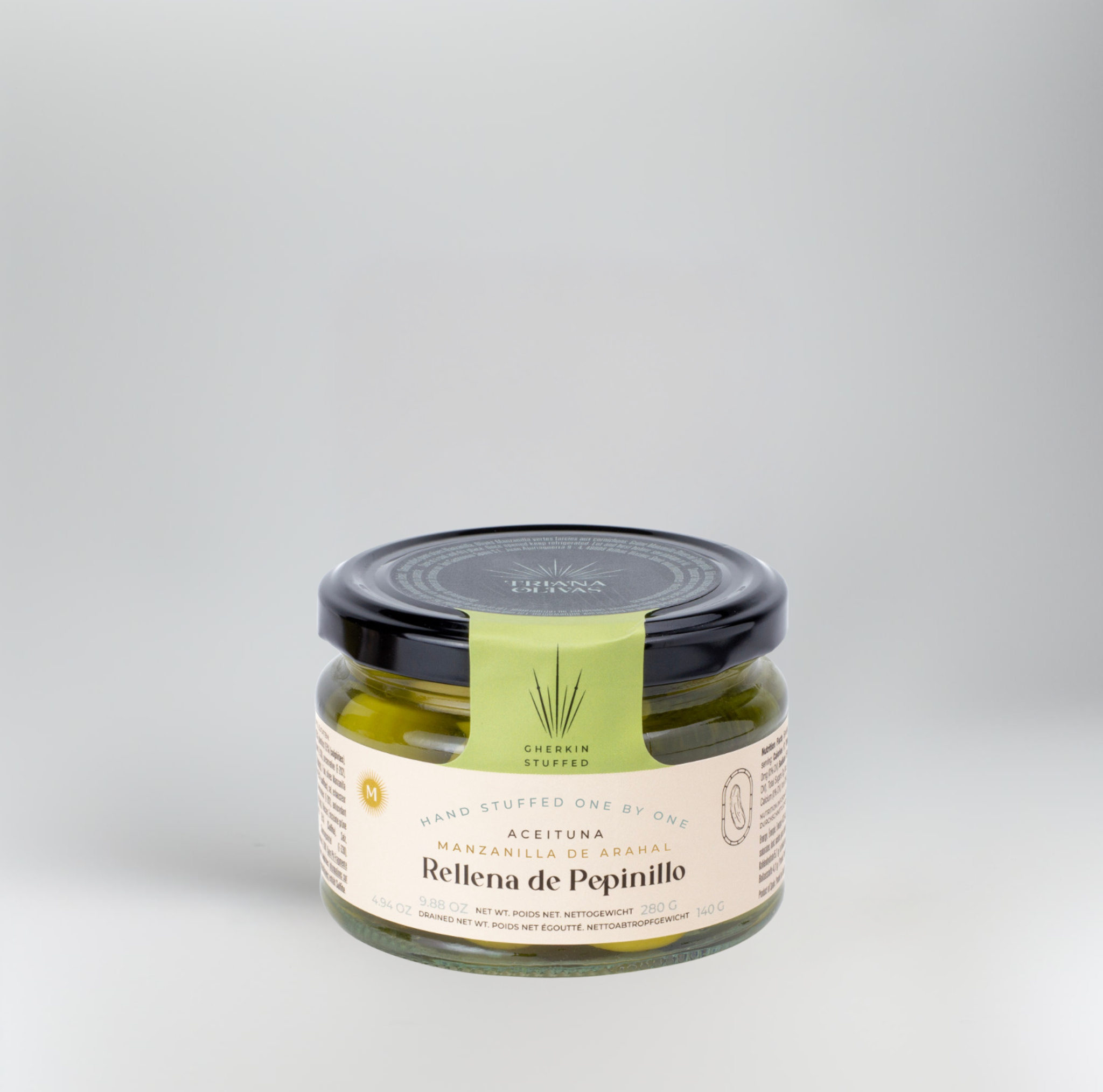 Jar of Rellena de Pepinillo on a gray background