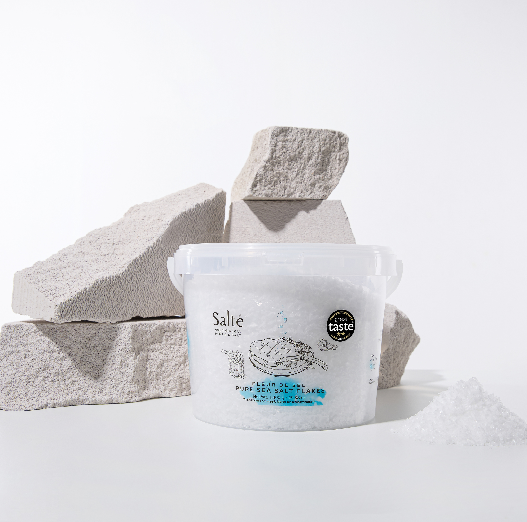 Container of Salte sea salt with salt blocks on a white background