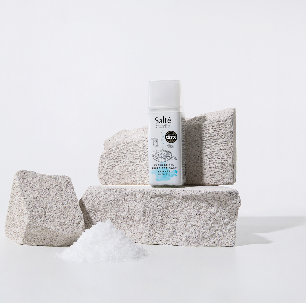 Salté product with textured stones and salt on a light background