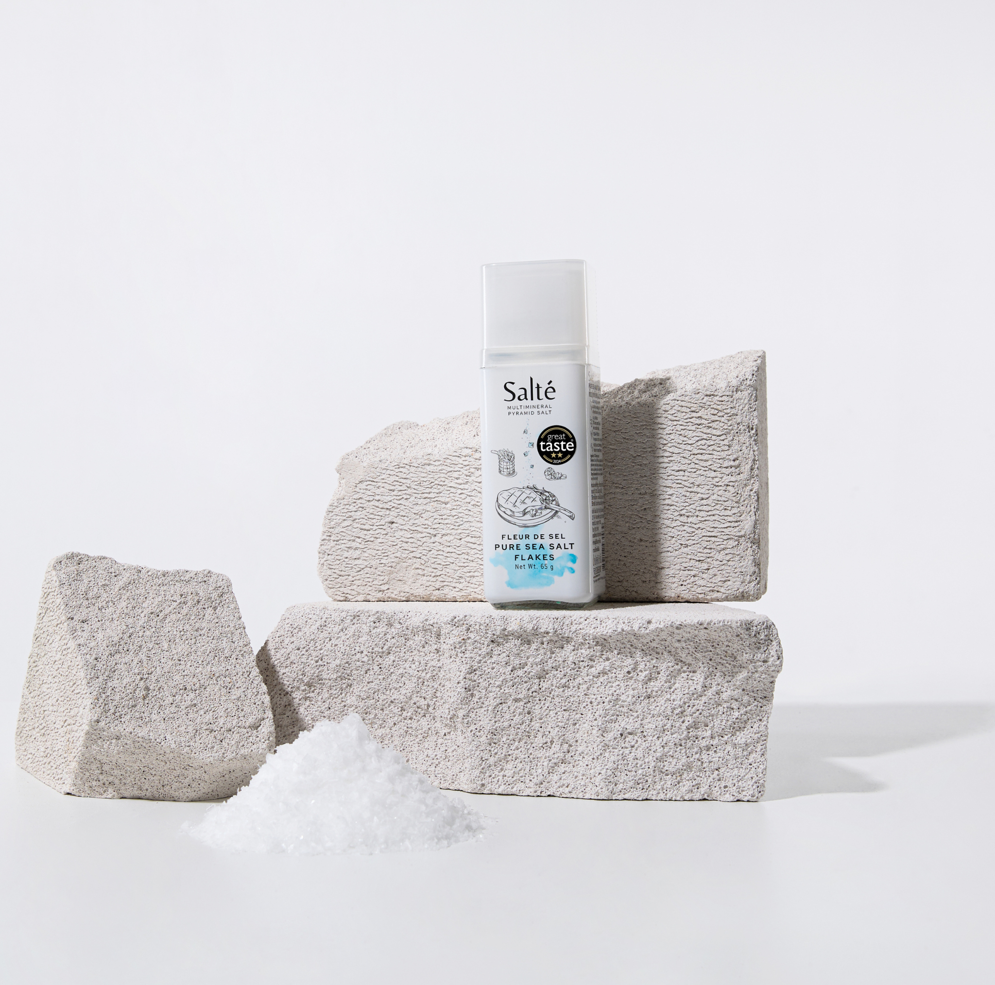 Salté product with textured stones and salt on a light background
